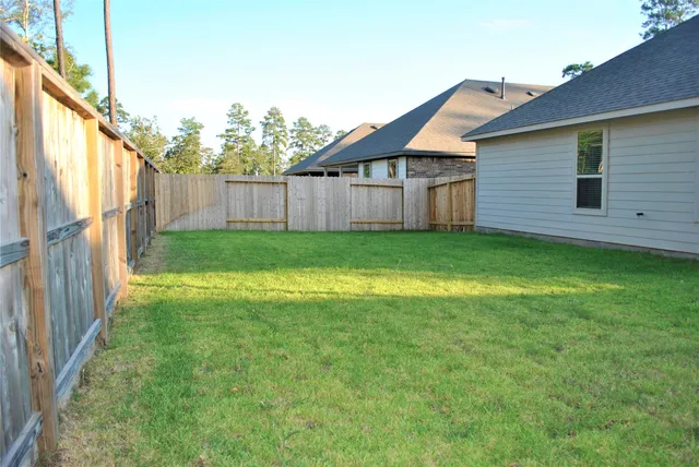 a front view of house with backyard and green space