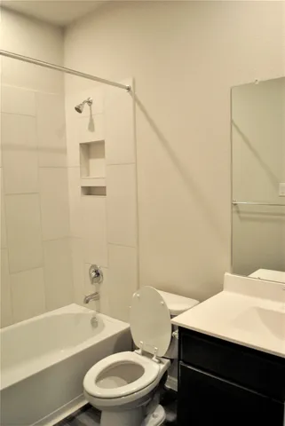 a view of a hallway with wooden floor and closet