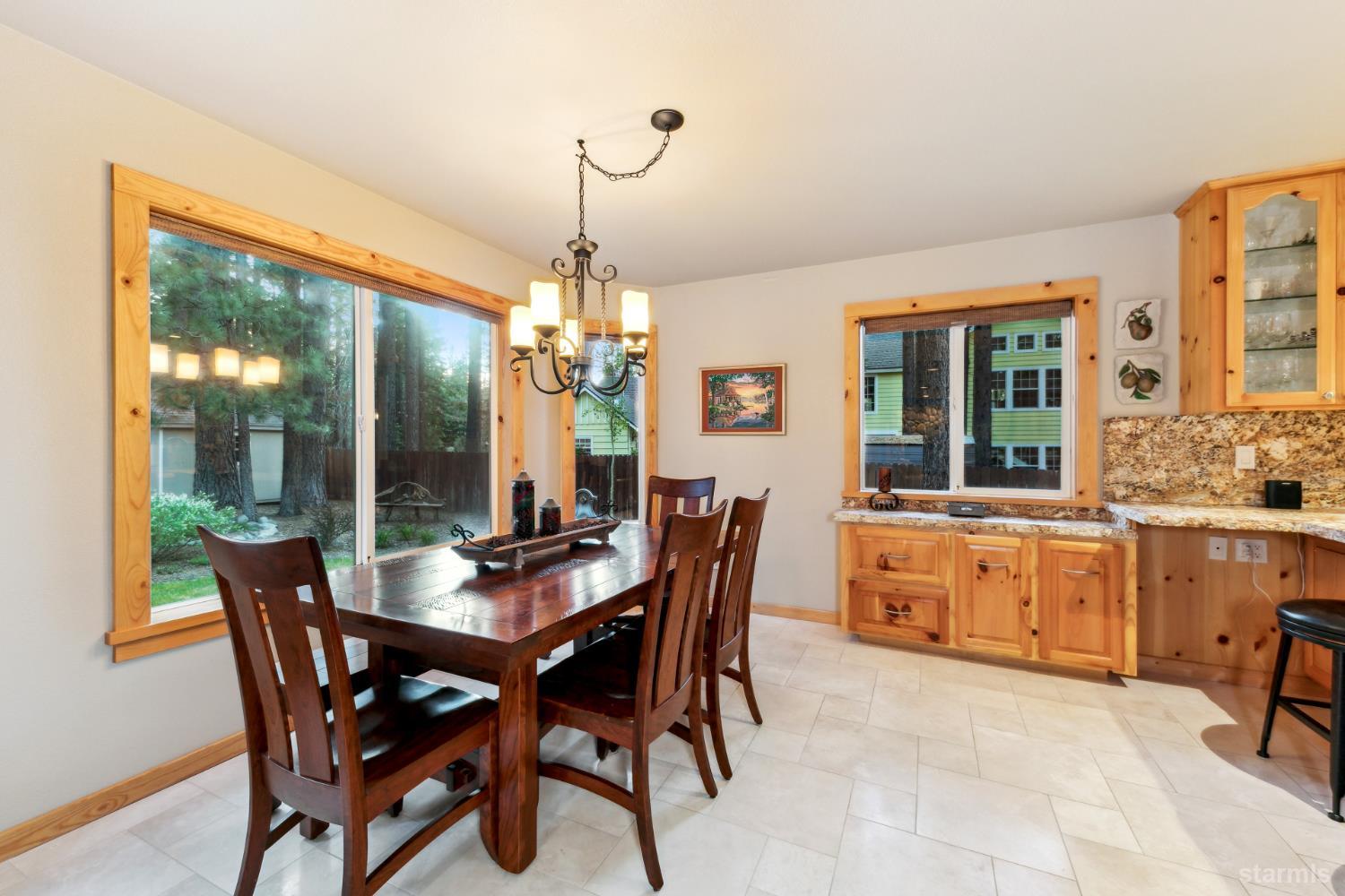 817 Kiowa Drive South Lake Tahoe, CA 96150 - Photo 12 of 39 a dining room with furniture a chandelier and wooden floor