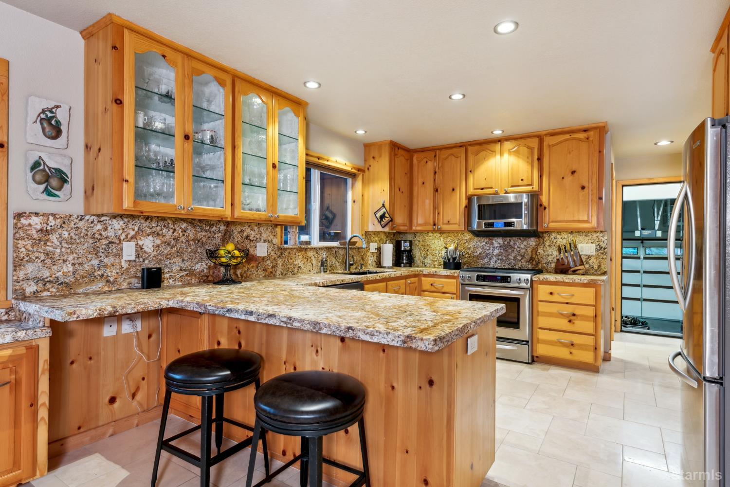817 Kiowa Drive South Lake Tahoe, CA 96150 - Photo 15 of 39 a kitchen with a stove a sink and a refrigerator