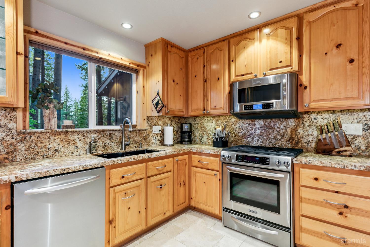 817 Kiowa Drive South Lake Tahoe, CA 96150 - Photo 16 of 39 a kitchen with stainless steel appliances granite countertop a sink stove and microwave