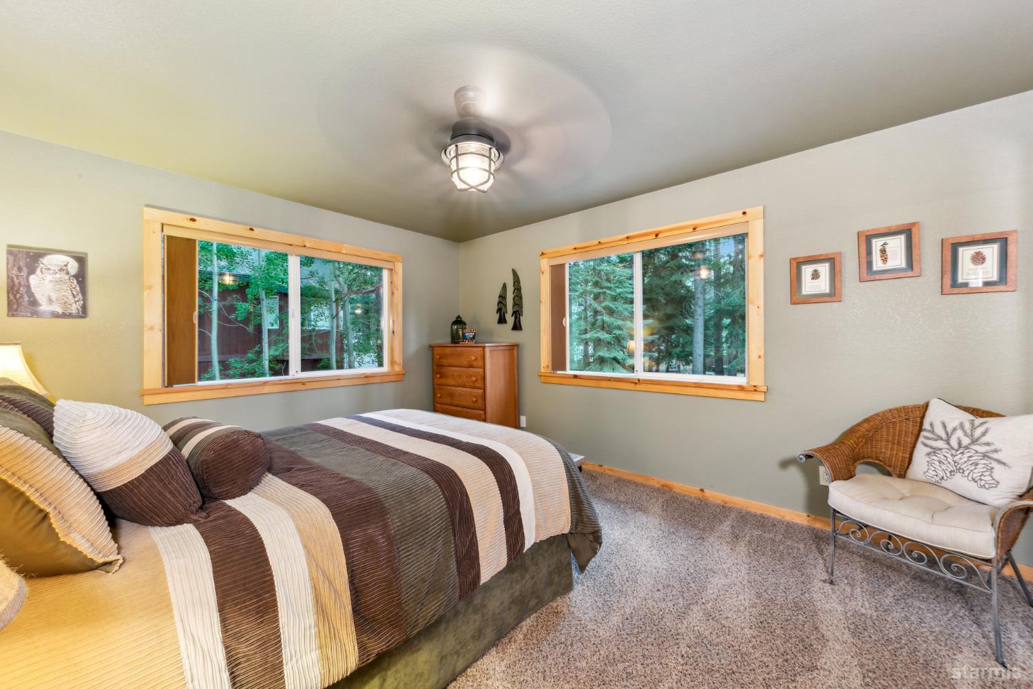 817 Kiowa Drive South Lake Tahoe, CA 96150 - Photo 28 of 39 a bedroom with a large bed and a window