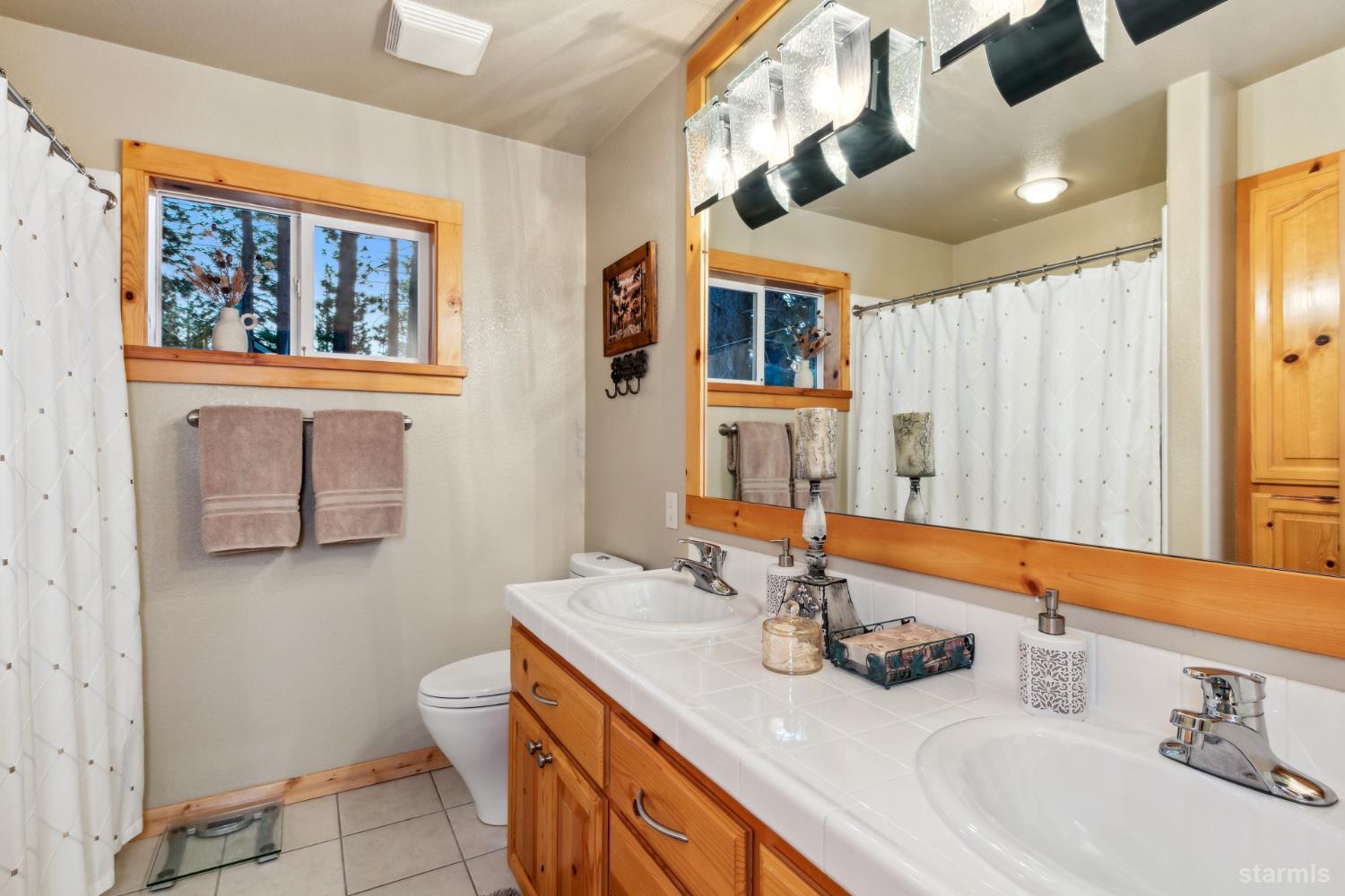 817 Kiowa Drive South Lake Tahoe, CA 96150 - Photo 29 of 39 a bathroom with a sink a toilet and mirror