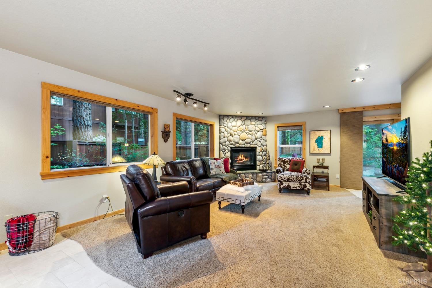 817 Kiowa Drive South Lake Tahoe, CA 96150 - Photo 8 of 39 a living room with furniture and a fireplace