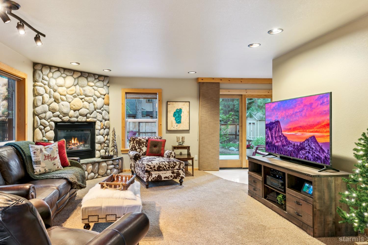 817 Kiowa Drive South Lake Tahoe, CA 96150 - Photo 9 of 39 a living room with furniture a flat screen tv and a fireplace