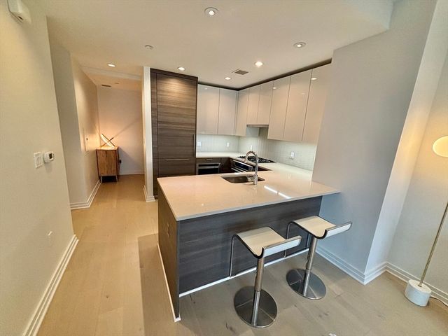 a view of a kitchen with a sink a table and chairs
