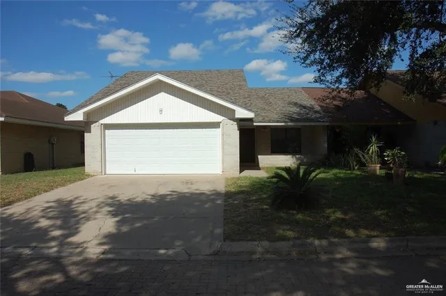 a view of a house with a yard and garage