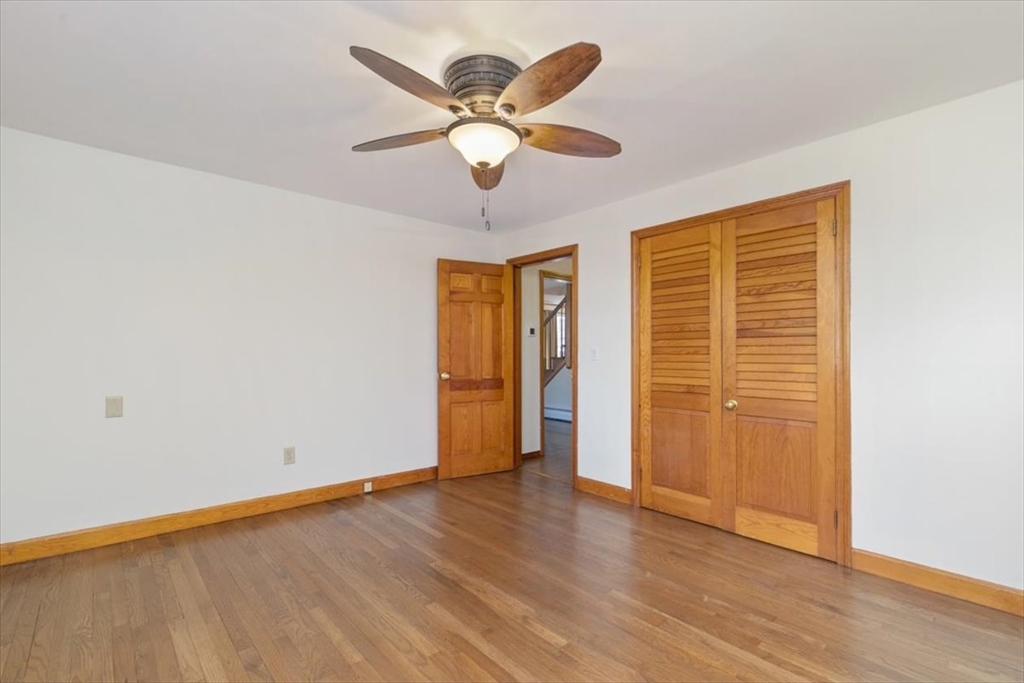 145 Warrenton Road Haverhill, MA 01832 - Photo 17 of 38 a view of an empty room with wooden floor and a window
