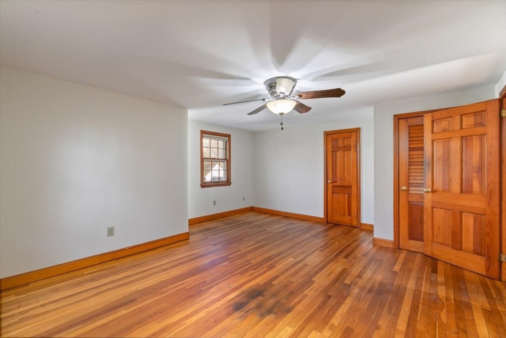 145 Warrenton Road Haverhill, MA 01832 - Photo 26 of 38 a view of empty room with wooden floor and fan