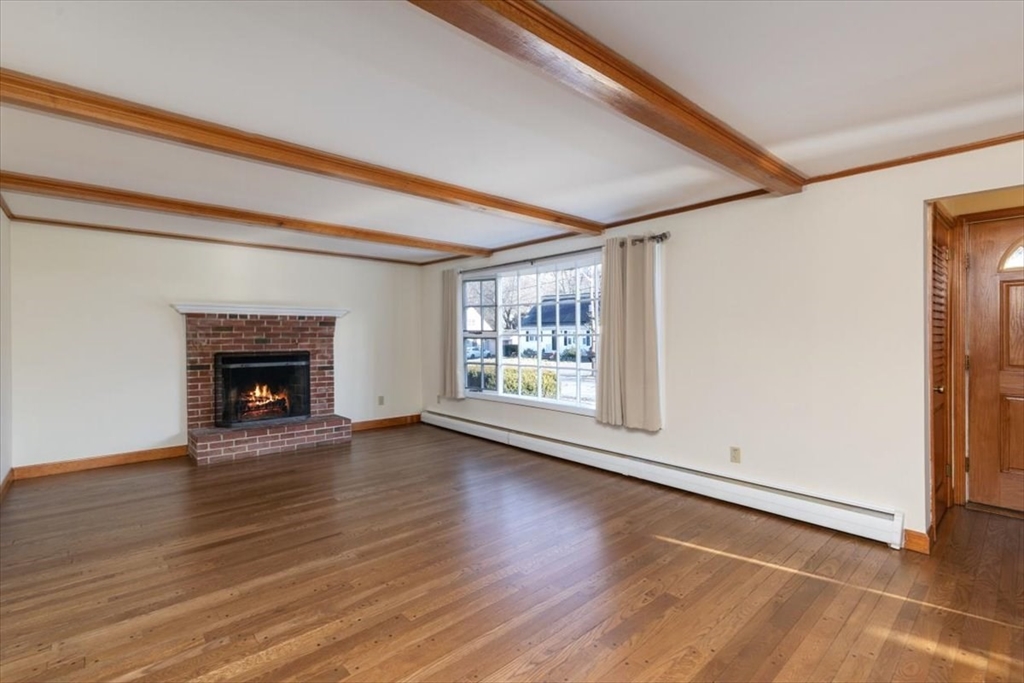 145 Warrenton Road Haverhill, MA 01832 - Photo 6 of 38 a view of an empty room with wooden floor and a window