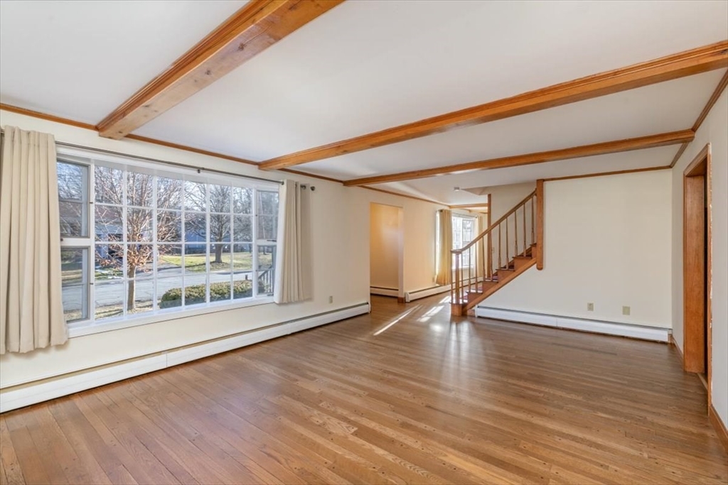 145 Warrenton Road Haverhill, MA 01832 - Photo 7 of 38 a view of an empty room with wooden floor and a window