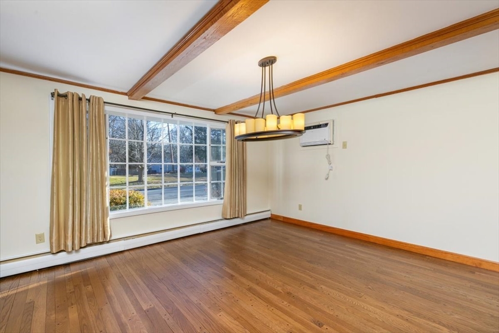 145 Warrenton Road Haverhill, MA 01832 - Photo 9 of 38 a view of an empty room with wooden floor and a window