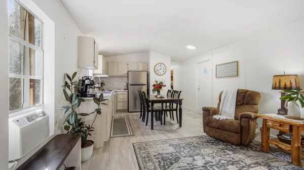 a view of a livingroom with furniture and a flat screen tv