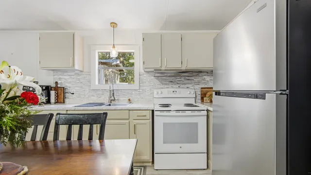 a kitchen with appliances cabinets and chair