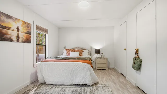 a bedroom with a bed and a window