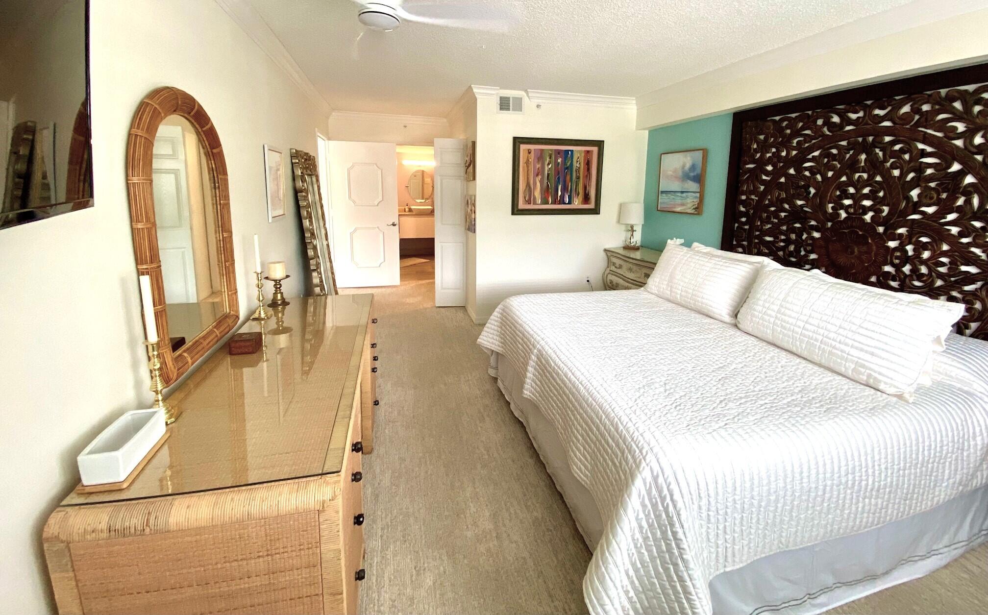 3594 South Ocean Boulevard, Unit 207 Highland Beach, FL 33487 - Photo 11 of 56 a spacious bedroom with a bed a couch and a potted plant