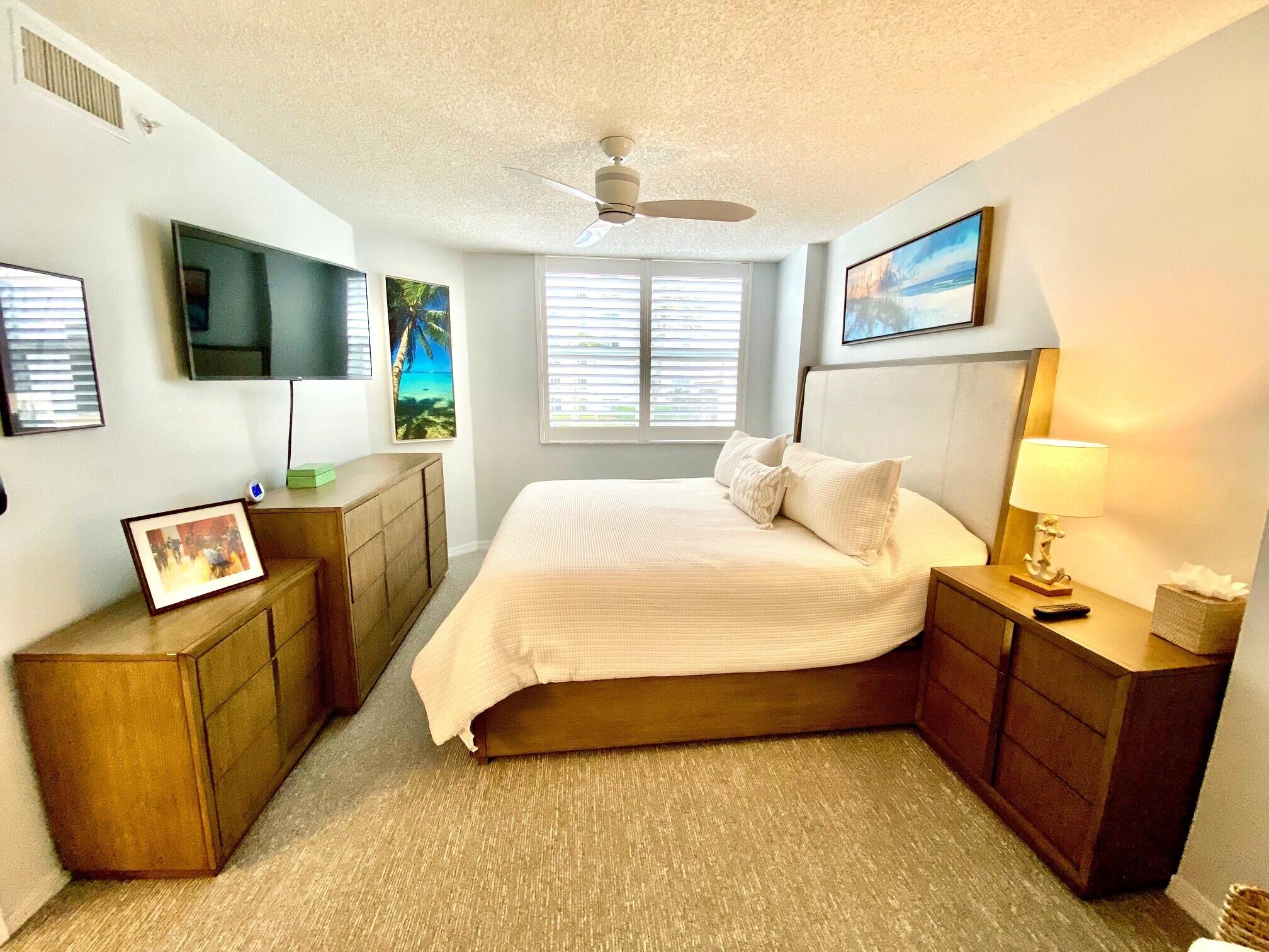 3594 South Ocean Boulevard, Unit 207 Highland Beach, FL 33487 - Photo 19 of 56 a spacious bedroom with a bed and a television