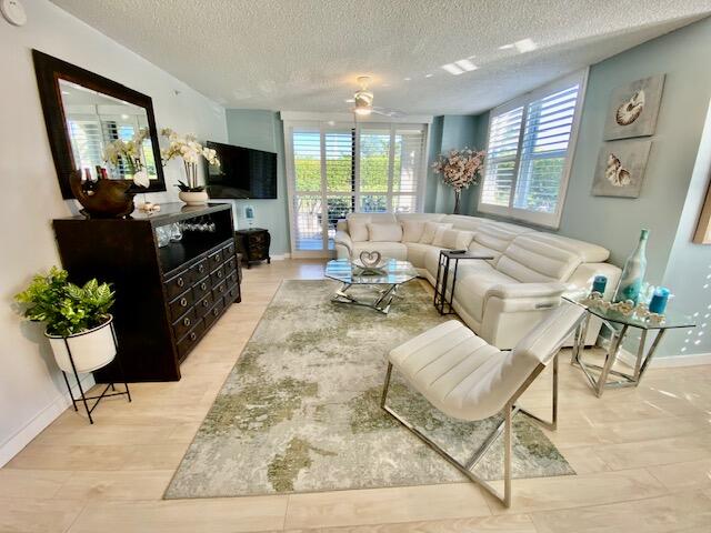 3594 South Ocean Boulevard, Unit 207 Highland Beach, FL 33487 - Photo 2 of 56 a living room with furniture large window and flat screen tv