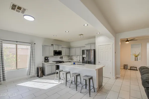 a kitchen with stainless steel appliances kitchen island granite countertop a sink and cabinets