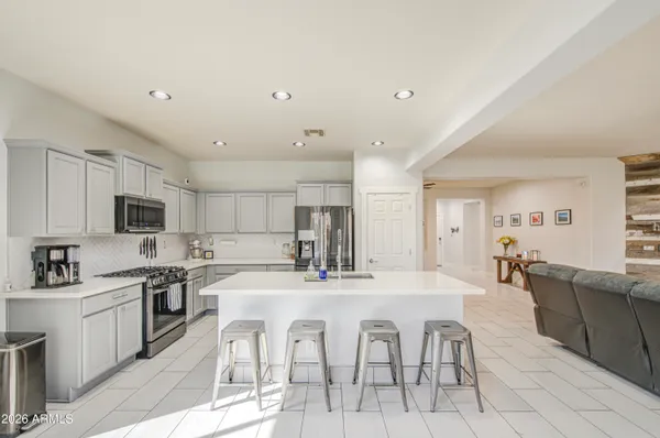 a kitchen with cabinets stainless steel appliances and sink