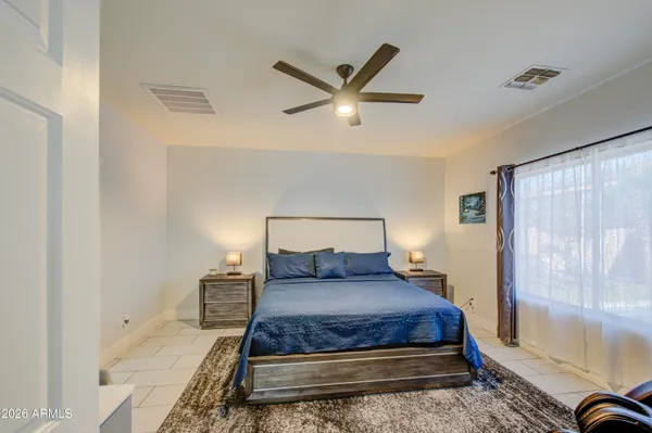 a bedroom with a bed and a chandelier