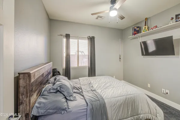 a bedroom with a bed and a mirror