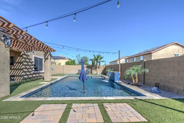a view of a patio with table and chairs potted plants with wooden floor and fence