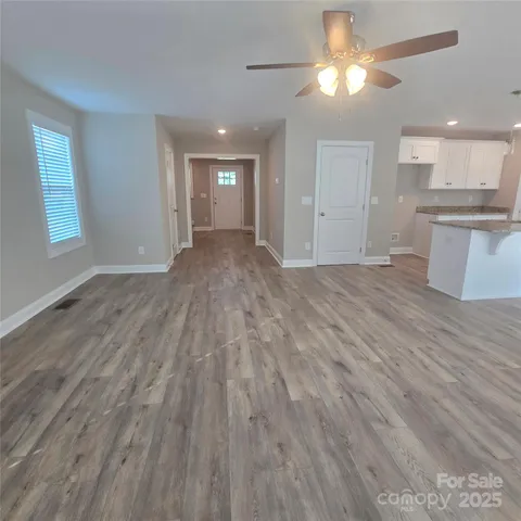 a view of a kitchen with kitchen island stainless steel appliances refrigerator cabinets and a fireplace