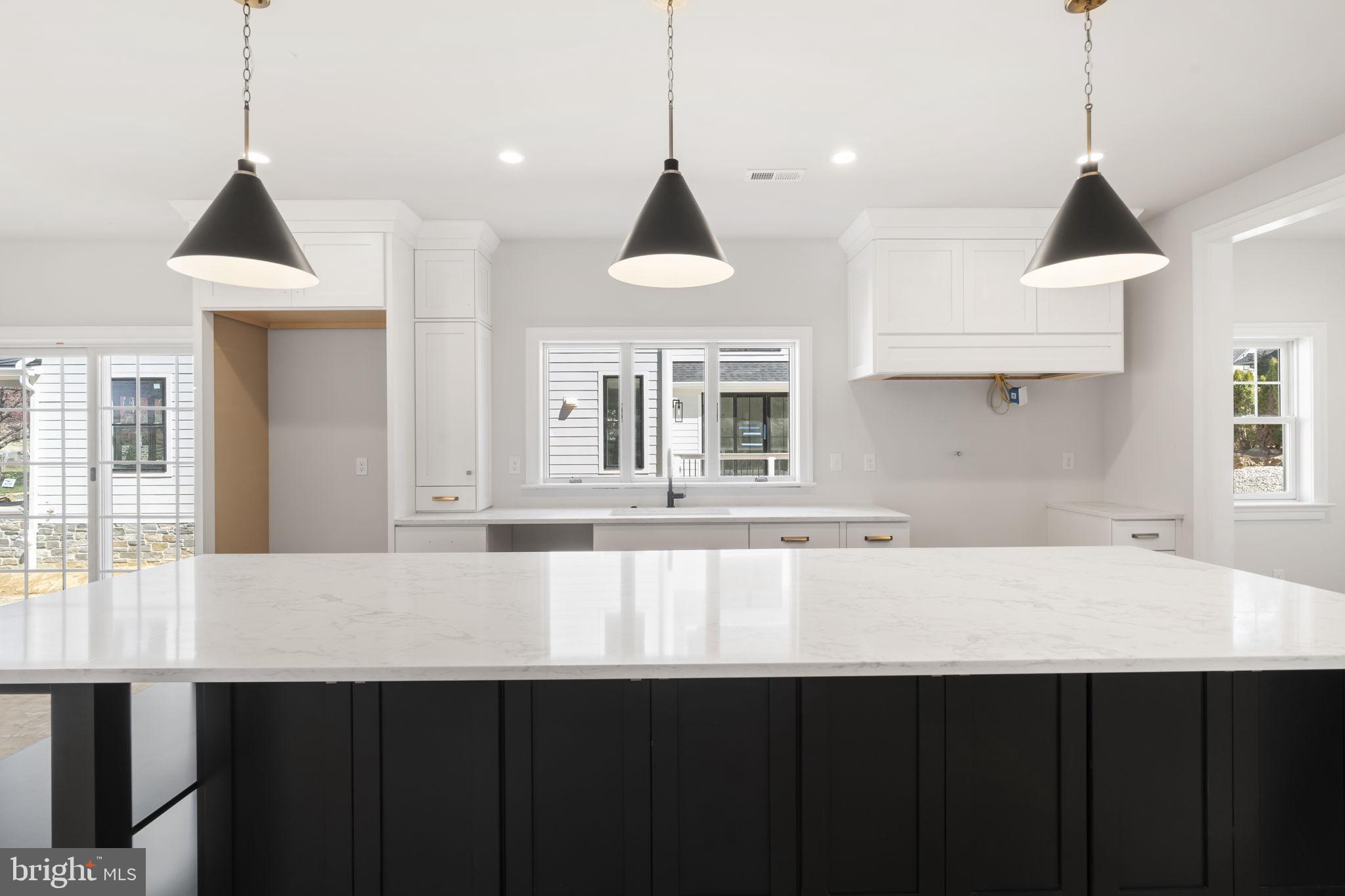 39 Simpson Road Ardmore, PA 19003 - Photo 13 of 49 a kitchen with a sink a window and wooden floor
