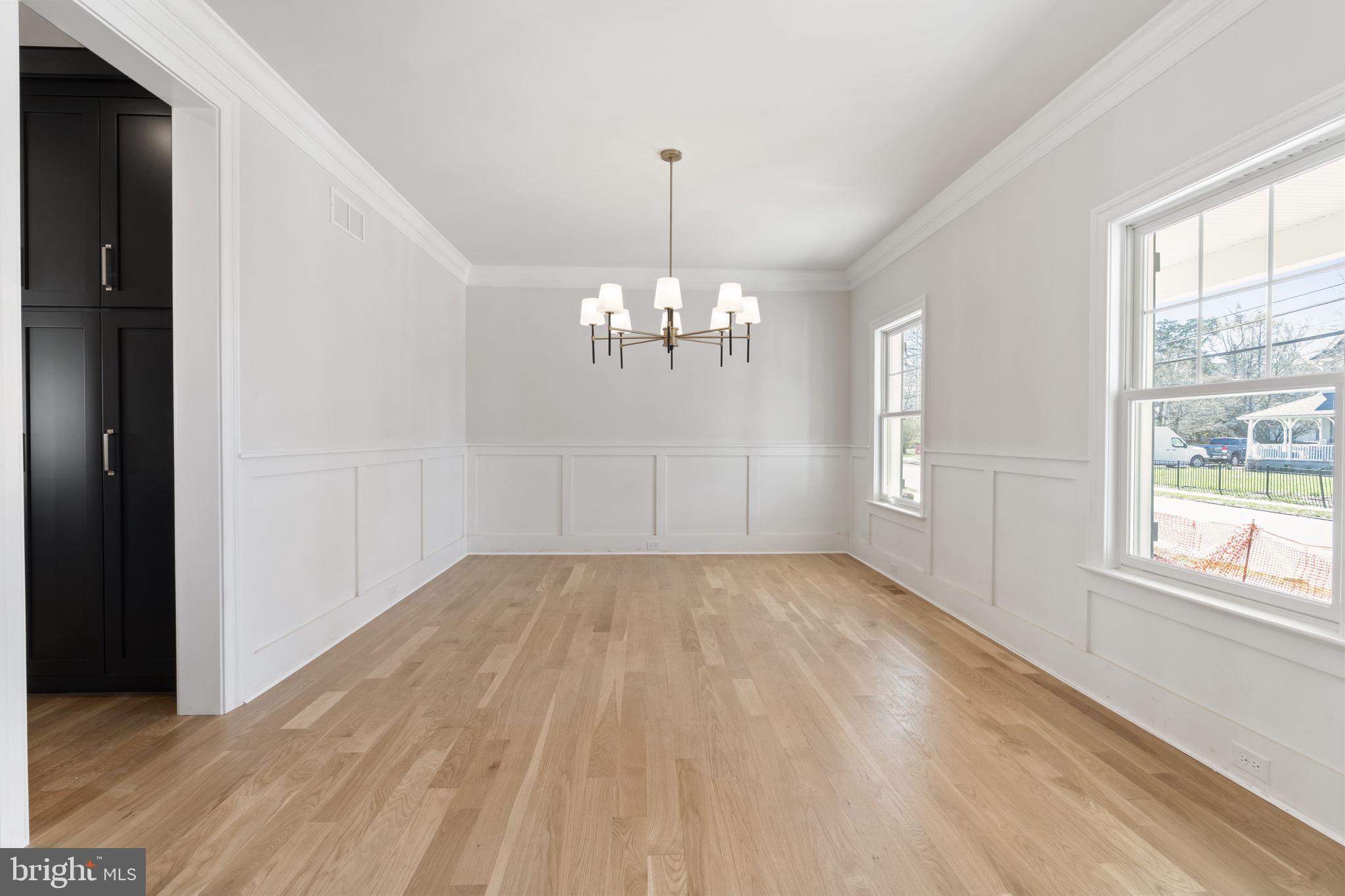 39 Simpson Road Ardmore, PA 19003 - Photo 15 of 49 a view of an empty room with chandelier and wooden floor