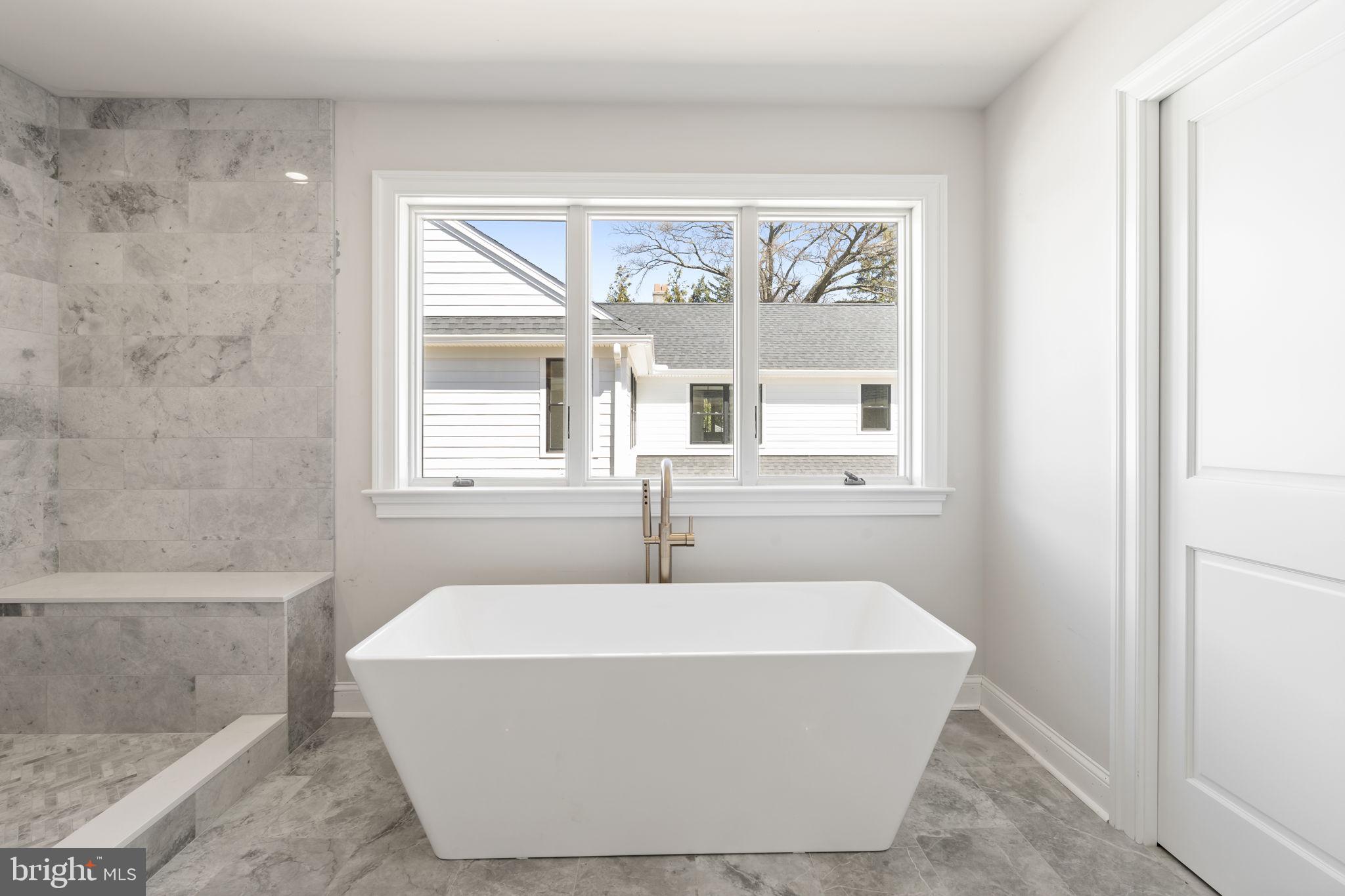 39 Simpson Road Ardmore, PA 19003 - Photo 32 of 49 a white bath tub sitting in a bathroom next to a window