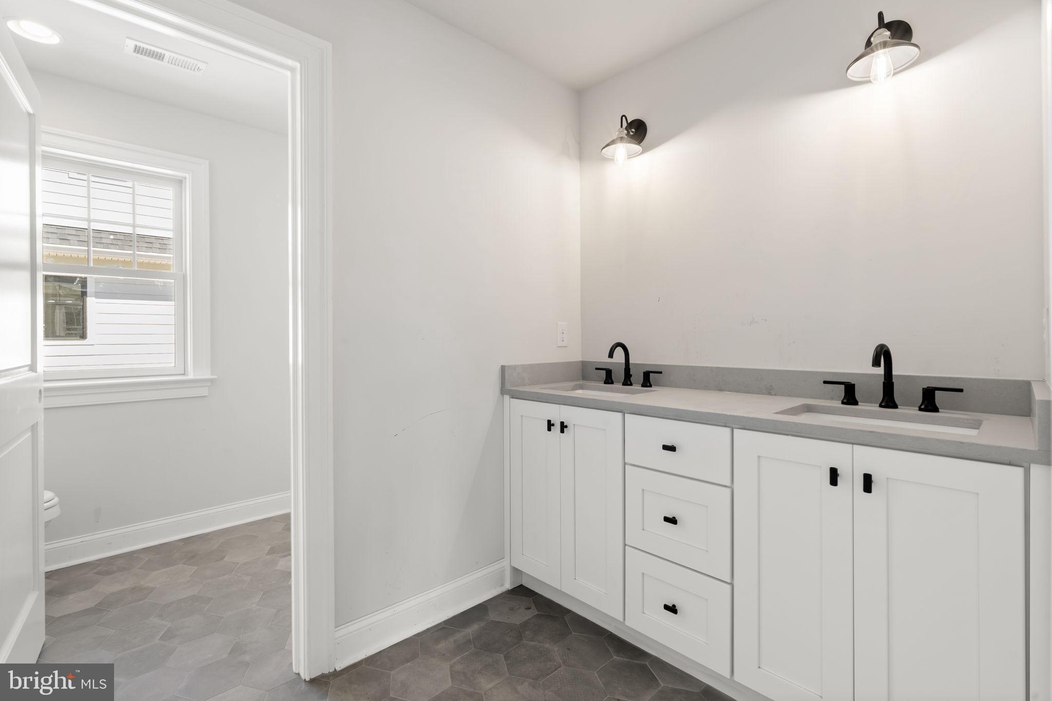 39 Simpson Road Ardmore, PA 19003 - Photo 36 of 49 a bathroom with double sink and a mirror