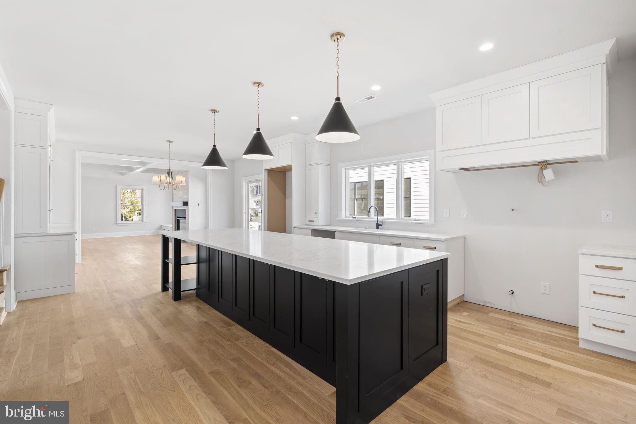 39 Simpson Road Ardmore, PA 19003 - Photo 4 of 49 a kitchen with kitchen island granite countertop a sink and cabinets