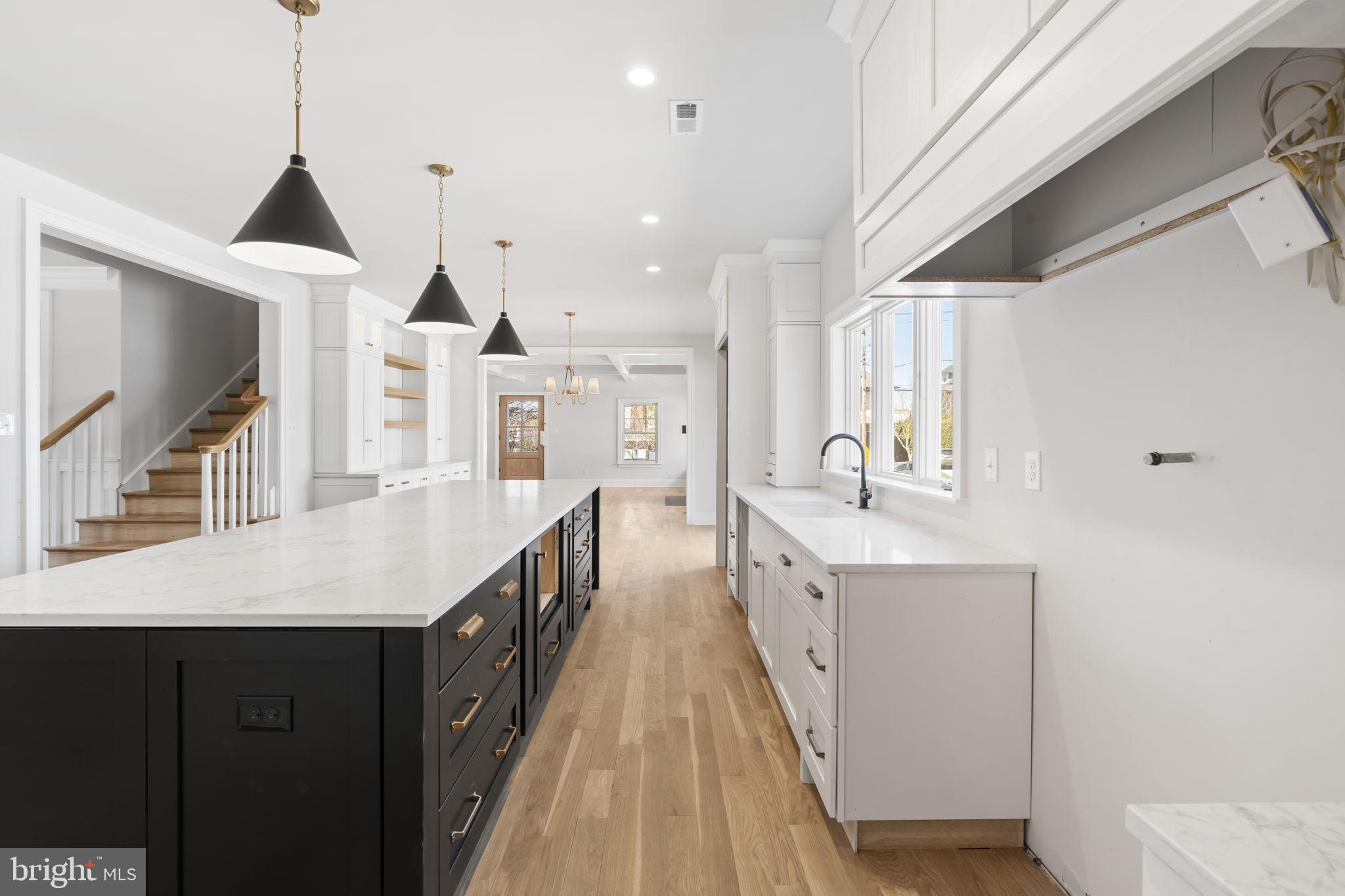 39 Simpson Road Ardmore, PA 19003 - Photo 5 of 49 a spacious kitchen with stainless steel appliances kitchen island a large counter tops and a chandelier