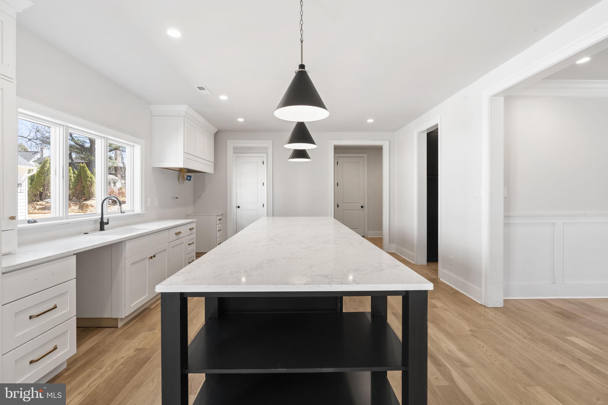 39 Simpson Road Ardmore, PA 19003 - Photo 6 of 49 a kitchen with a dining table chairs sink and wooden floor