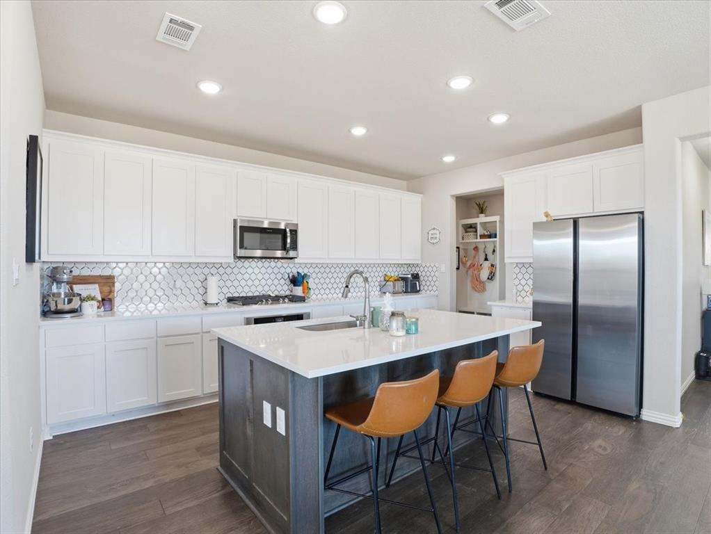 312 Welch Folly Lane Aledo, TX 76008 - Photo 12 of 33 a large kitchen with kitchen island a sink table and chairs