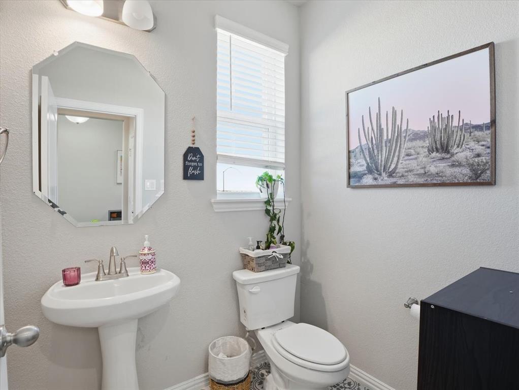 312 Welch Folly Lane Aledo, TX 76008 - Photo 19 of 33 a bathroom with a toilet a sink and a mirror