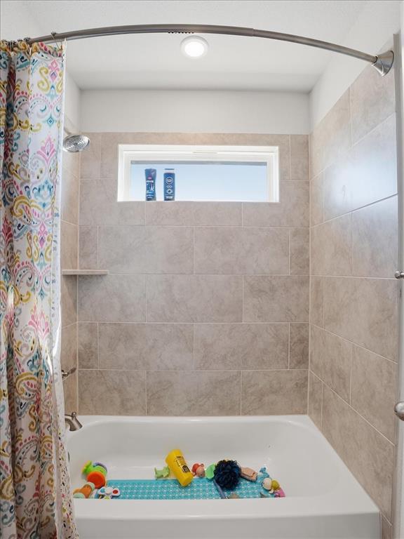 312 Welch Folly Lane Aledo, TX 76008 - Photo 26 of 33 a bathroom with a bathtub and a shower