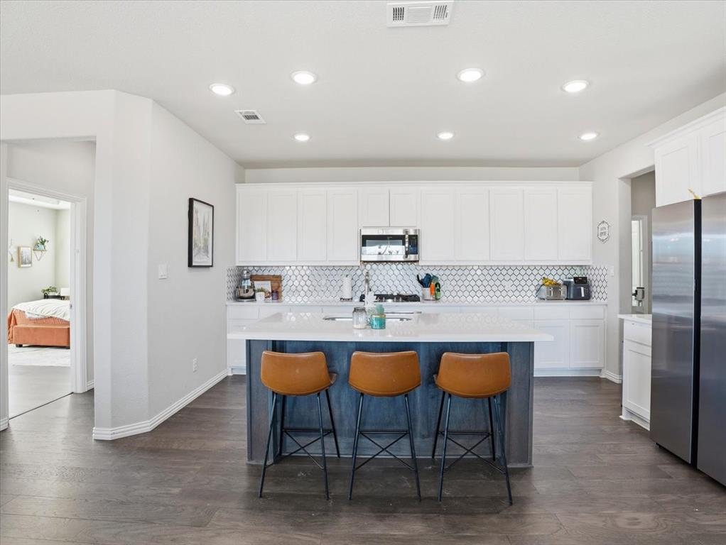 312 Welch Folly Lane Aledo, TX 76008 - Photo 10 of 33 a kitchen with stainless steel appliances granite countertop a table chairs sink and cabinets