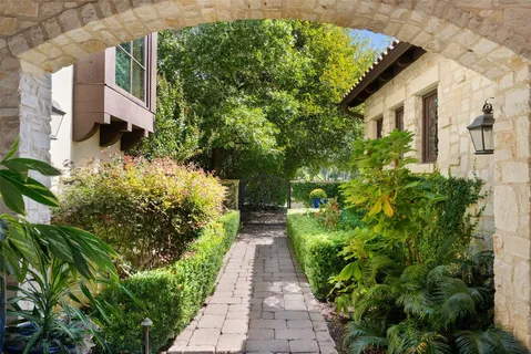 a view of a pathway with flower plants