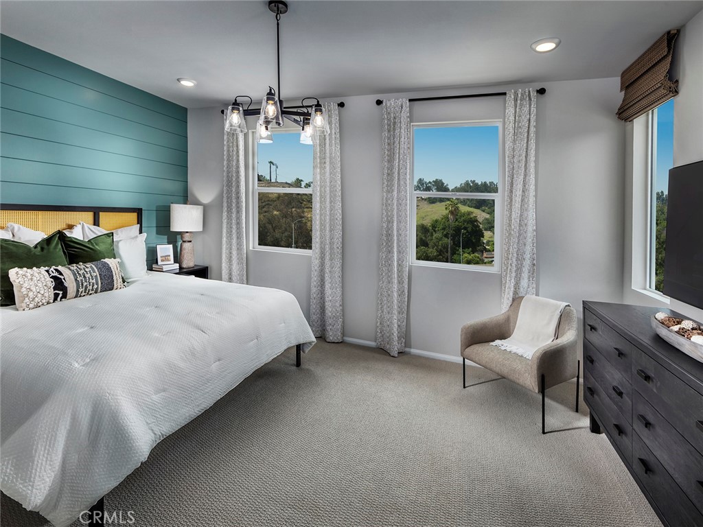 4869 Merida Way Oceanside, CA 92057 - Photo 11 of 13 a spacious bedroom with a bed and a flat tv screen