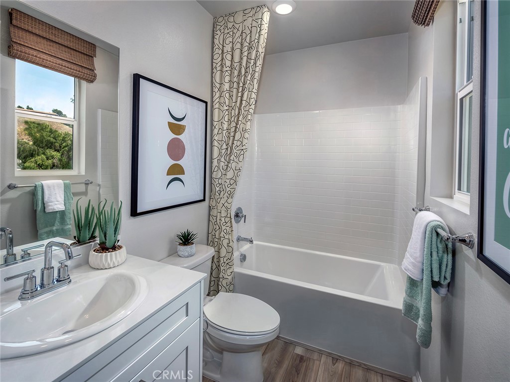 4869 Merida Way Oceanside, CA 92057 - Photo 9 of 13 a bathroom with a sink and a mirror