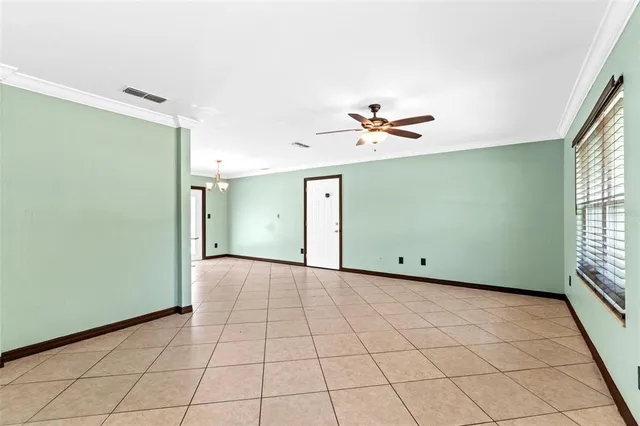 a view of a livingroom with a ceiling fan and window