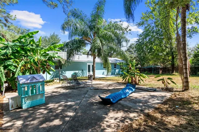 a view of a park with lawn chairs and a fire pit