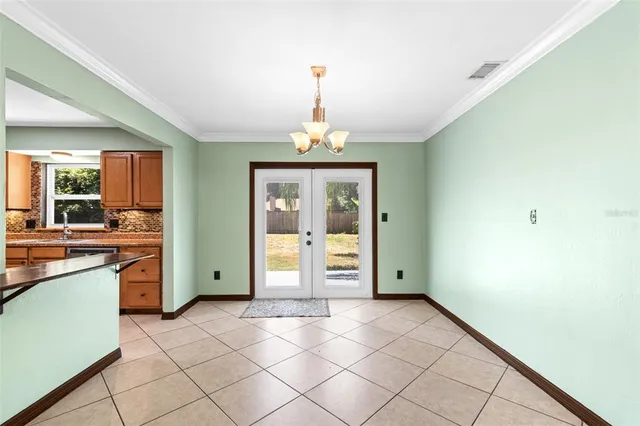 a view of an empty room with window and cabinet