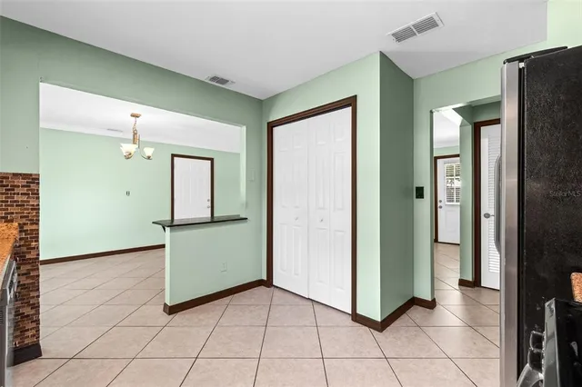 a view of a kitchen with refrigerator and mirror