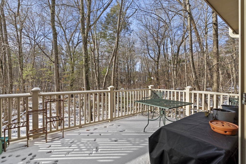 4 Apple Ridge Road, Unit 6 Maynard, MA 01754 - Photo 29 of 40 a view of a chair and table on the deck