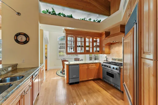 a kitchen with stainless steel appliances granite countertop a stove and a refrigerator