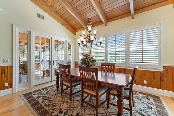 a view of a dining room with furniture wooden floor and chandelier