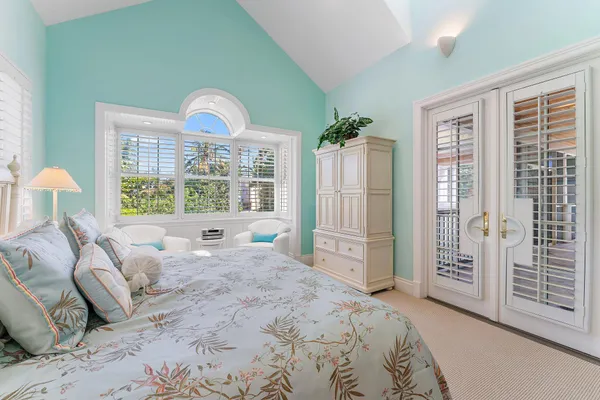 a bedroom with a bed and a large window